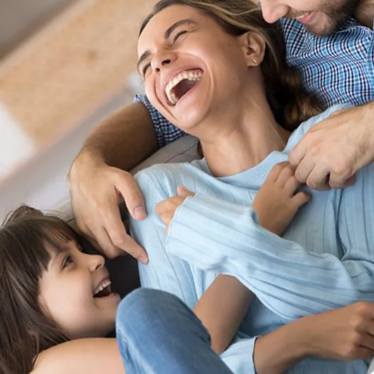 woman laughing with family after addiction recovery