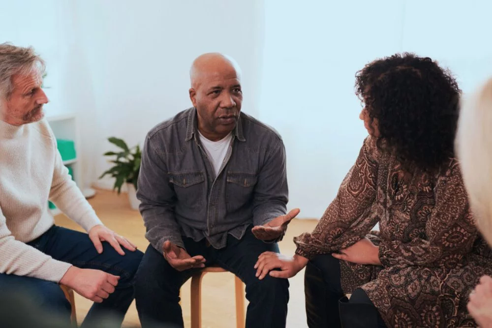 man in serious conversation in therapy for addiction