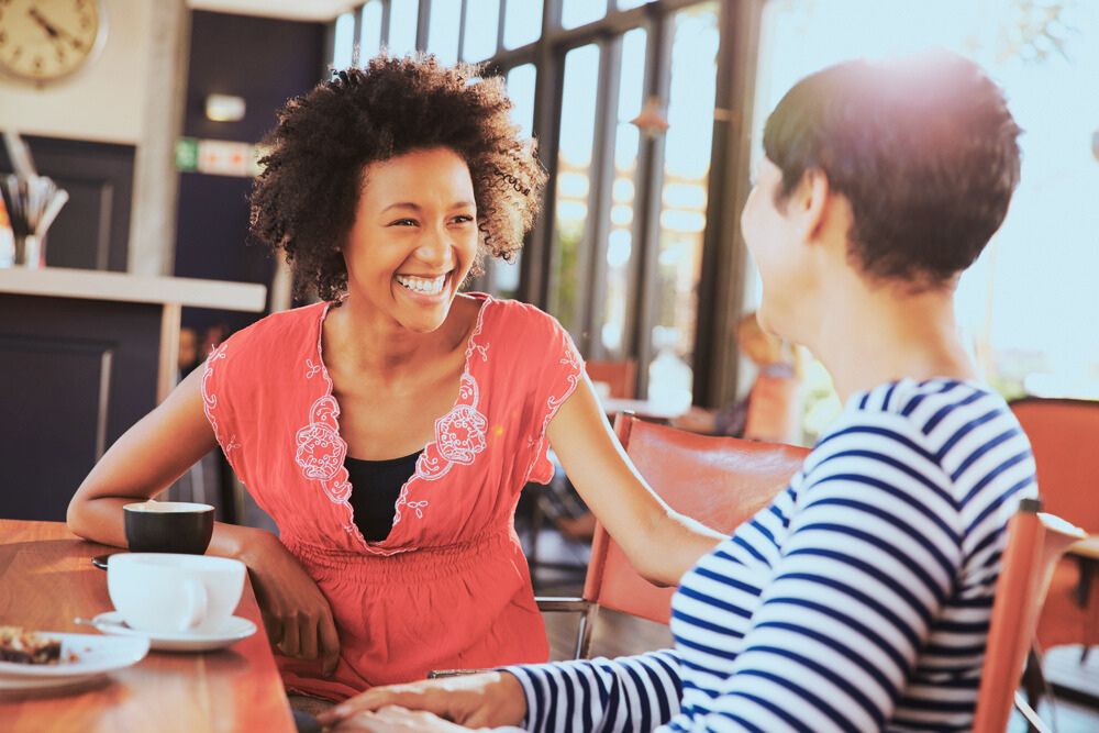 two women smiling and chatting in residential rehab